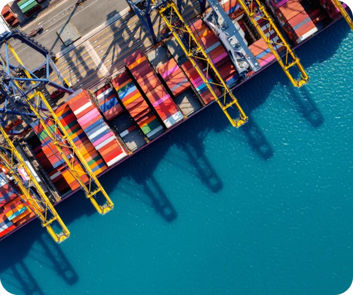 Cargo ship beside container terminal cranes